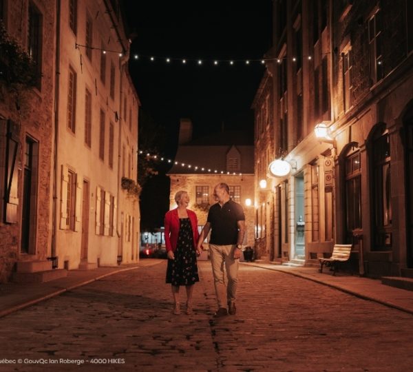Nächtlicher Spaziergang durch die Altstadt von Québec City: Kopfsteinpflaster und warm beleuchtete historische Gassen mit Blick auf die Fassaden. Kanada-Rundreise