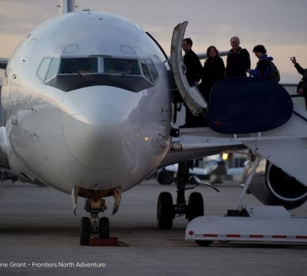 Passagiere steigen über eine mobile Treppe in ein Flugzeug für die Reise nach Churchill und Winnipeg ein. Kanada-Rundreise
